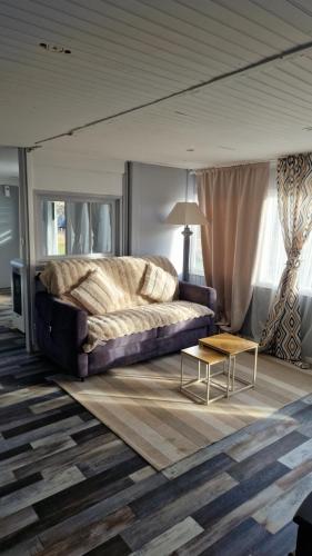a bedroom with a large bed and a coffee table at Chalet in Saint-Anthème