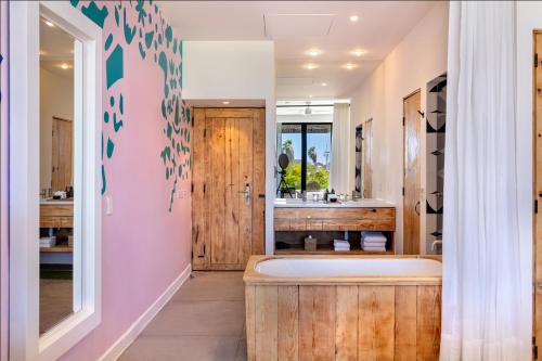 a bathroom with a tub and a sink at Hotel El Ganzo - Adults Only in San José del Cabo