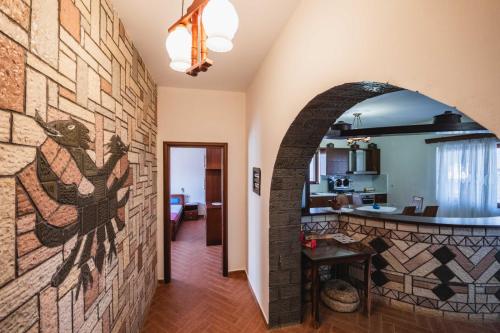 a hallway with a stone wall with a mural on it at Garden Villa Dhesara in Ksamil