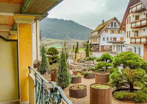 a balcony with a bunch of trees and plants at Ailwaldhof Parkhotel & Spa in Baiersbronn