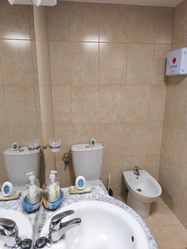 a bathroom with a sink and a toilet at Casa el Alfar mudéjar in Teruel
