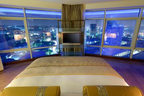 a bedroom with a large bed and a large window at Wyndham Grand Istanbul Europe in Istanbul