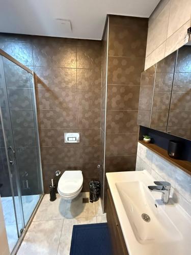 a bathroom with a toilet and a sink and a shower at Serenity Residence lux1plus1 in Alanya