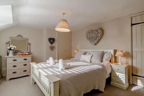 a bedroom with a large white bed and a mirror at 4 Bed in Westleton oc-s27303 in Westleton