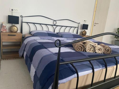 a bedroom with a bed with blue sheets and pillows at Wellness Varaždin in Varaždin