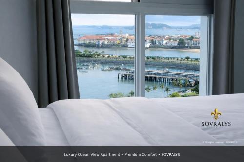a bedroom with a window with a view of a harbor at 80M Luxury Ocean View Apartment PH The Sands, Next to Hilton in Panama City
