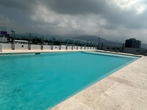 a large swimming pool on top of a building at Beautiful 2 bedrooms condo with pool Livo Tower in Monterrey