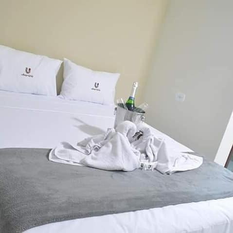 a baby wrapped in towels sitting on a bed at Flat Ubarana Maragogi-AL in Maragogi