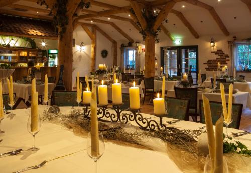 a dining room with candles on a table at Hotel Backenköhler in Ganderkesee