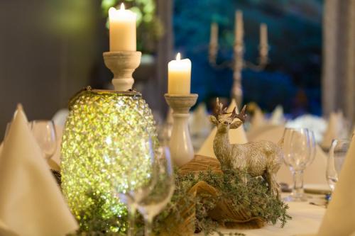 a table with candles and figurines of animals on it at Hotel Backenköhler in Ganderkesee