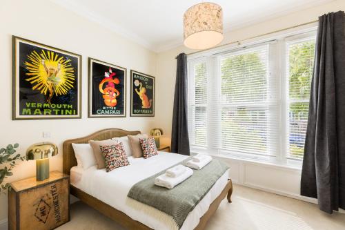 a bedroom with a bed and a window at Maitland House Boutique Apartment in Gloucestershire
