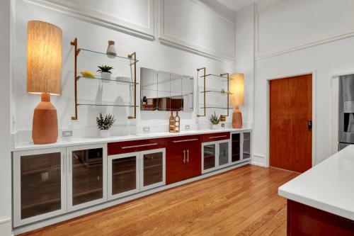 a kitchen with white walls and a wooden floor at Luxe 220 Suite 3 in Wilmington