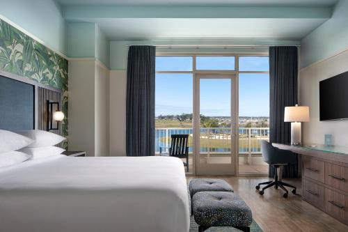 a hotel room with a bed and a large window at Hotel Eastport in The Villages