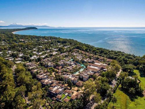 an aerial view of a subdivision of houses next to the water at Pullman Port Douglas Sea Temple Resort and Spa in Port Douglas