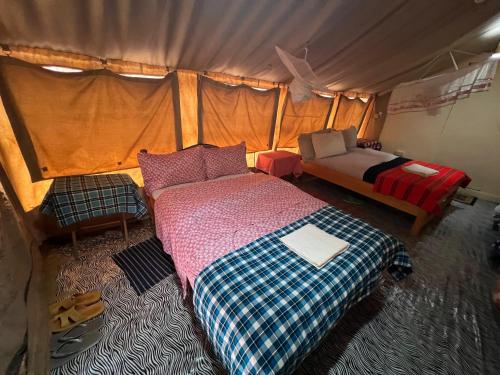 a bedroom with a bed in a tent at leyianmaasaisafaris in Narok