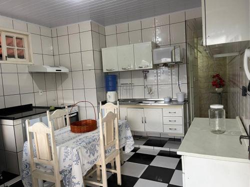 a kitchen with a table and two chairs in it at Castelo Princesa Isabel in Ouro Preto