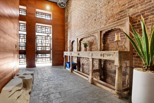 a room with a brick wall and a fireplace at Luxe 220 Suite 5 in Wilmington