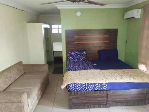 a bedroom with a bed and a couch at Classic Hotel by TWM in Ibadan