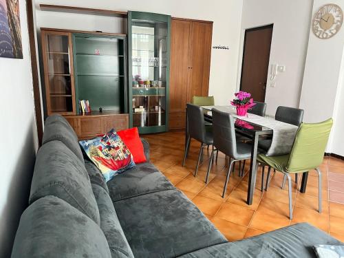 a living room with a couch and a table with chairs at Ziva's house apartment in Abbiategrasso in Abbiategrasso