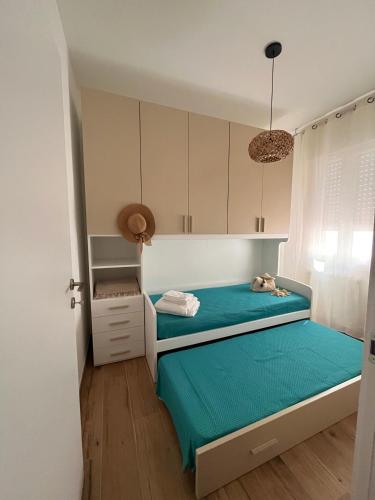 a small bedroom with a bed and a cabinet at Ca' dei Venti in Chioggia