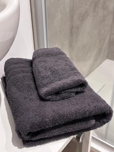a gray towel sitting on top of a bathroom sink at Pendler Montagewohnung Kandern, Lörrach, Basel D,CH, FR in Holzen