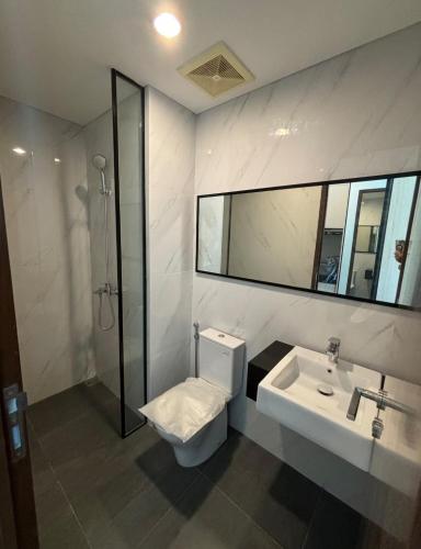 a bathroom with a toilet and a sink and a shower at Newton 1 CBD Jakarta Sudirman in Jakarta