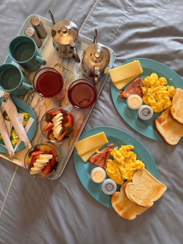a table with plates of breakfast foods and tea at Casa Hibiscus Boutique Hotel in Cuenca