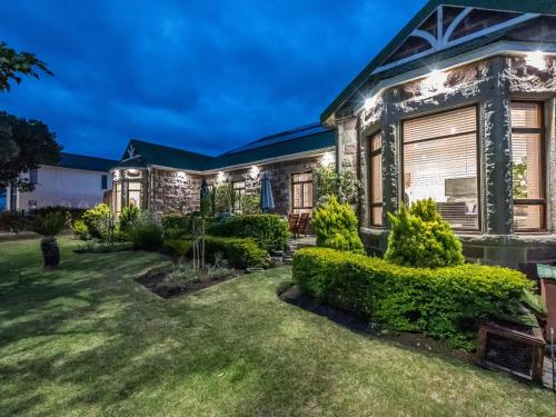 a house with a garden at night at Lilla-Bett Self Catering Mossel Bay in Mossel Bay
