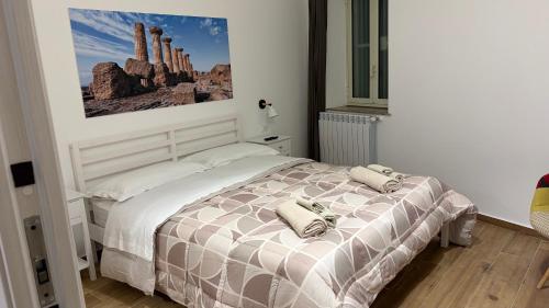 a bedroom with a bed with two pillows on it at Tra Mare e Mito in Agrigento