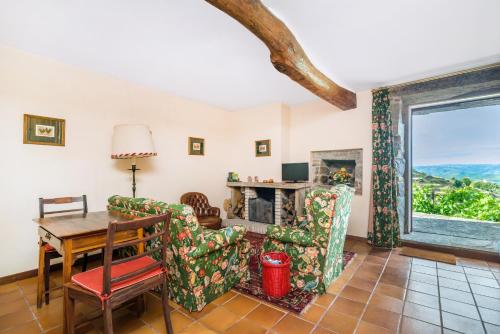 a living room with a table and chairs and a fireplace at Quinta de Santa Júlia in Peso da Régua