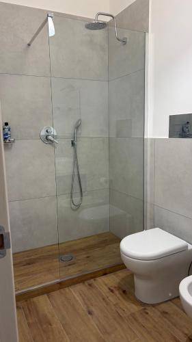 a bathroom with a glass shower with a toilet at Tra Mare e Mito in Agrigento