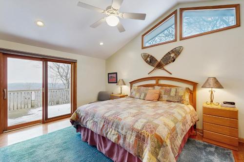 a bedroom with a bed and a ceiling fan at Peaks & Pines Escape in Beech Mountain