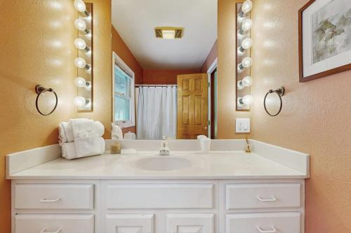 a bathroom with a white sink and a mirror at Peaks & Pines Escape in Beech Mountain