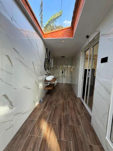 a skylight in a bathroom with a sink and a window at Modern Studio with Swimming Pool in Njiro, Arusha in Arusha