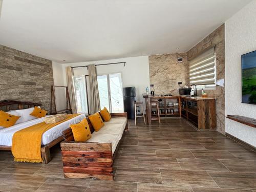 a bedroom with a bed and a couch and a desk at Modern Studio with Swimming Pool in Njiro, Arusha in Arusha