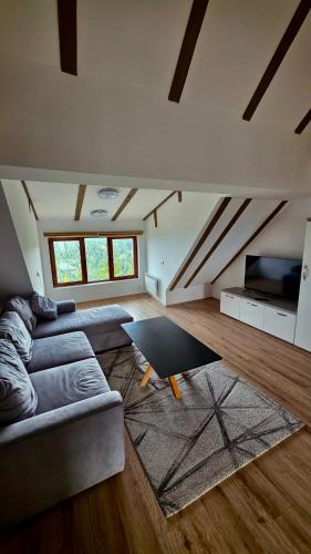 a living room with two couches and a flat screen tv at The Pine Loft by Kopaonik in Kopaonik
