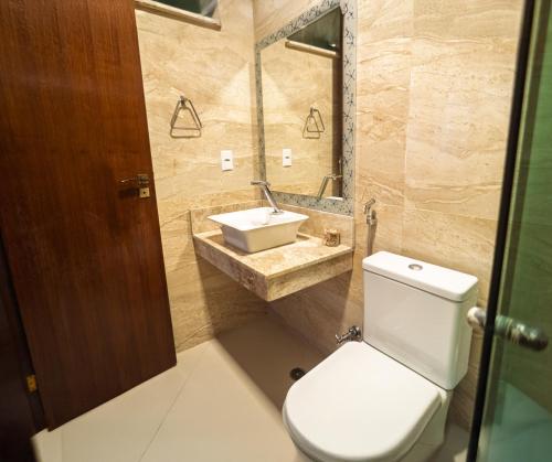 a bathroom with a toilet and a sink at Pousada Porto 23 in Morro de São Paulo