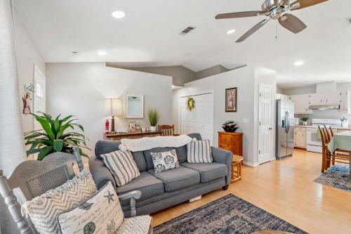 a living room with a couch and a kitchen at Life's a Breeze - 5min to Pcola Beach , Families in Gulf Breeze