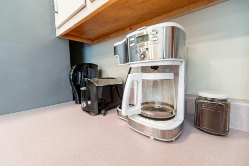 a coffeemaker sitting on top of a kitchen counter at Life's a Breeze - 5min to Pcola Beach , Families in Gulf Breeze