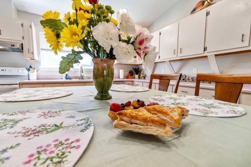 a table with two plates of food and flowers at Life's a Breeze - 5min to Pcola Beach , Families in Gulf Breeze
