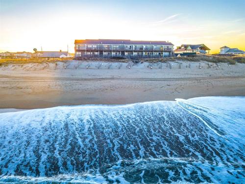 a view of a beach with a building in the background at SW6 - Seawalk 6 in Kill Devil Hills