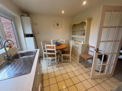 a kitchen with a sink and a table and a kitchen with a dining room at Cosy 2bed house in Oxford, sleeps 4 and a baby in Oxford