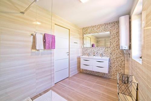 a bathroom with a shower and a sink at House Dawn in Rab