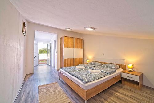 a bedroom with a large bed in a room at House Dawn in Rab