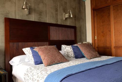 a bedroom with a bed with pillows on it at Hostal Don Peque in Nerja