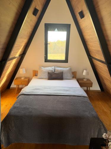 a bedroom with a large bed in a attic at Villa Šašava in Bosanska Gradiška