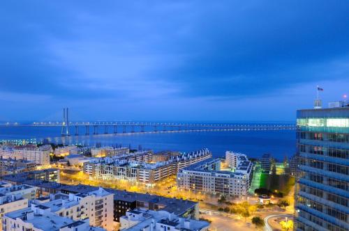 a view of a city with a pier at night at Panoramic Living in Lisbon