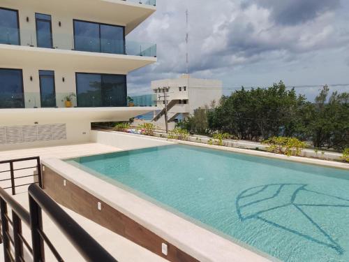 a swimming pool on the balcony of a building at Modern studio in a waterfront building in Cozumel