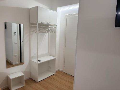 a bathroom with white cabinets and a mirror at B&B Sant'Angelo Sala Consilina in Sala Consilina