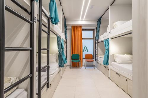 a corridor of a dorm room with bunk beds at BaruHaus GRUPOS Alea ALOJAMIENTO COMPLETO in León
